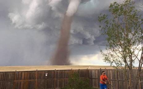 Canadian mows his lawn as tornado rages behind him