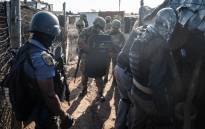 Members of the South African Police Service's Special Task Force raiding shacks in Zamimphilo informal settlement near Riverlea on 2 August 2023. Picture: Jacques Nelles/Eyewitness News