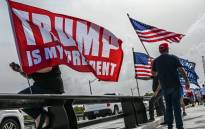 Supporters of former US President Donald Trump gather near his residence at Mar-A-Lago in Palm Beach, Florida, on 9 August 2022. Former US President Donald Trump said on 8 August 2022, that his Mar-A-Lago residence in Florida was 'raided' by FBI agents in what he called an act of 'prosecutorial misconduct.' Picture: Giorgio VIERA/AFP