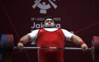 FILE: Pakistan's Mohammad Nooh Dastgir Butt attempts a lift during the men's +105kg weightlifting event at the 2018 Asian Games in Jakarta. Picture: AFP