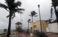 Palm trees blow in the wind before Hurricane Agatha makes landfall in Huatulco, Oaxaca State, Mexico on May 30, 2022. Hurricane Agatha, the first of the season, made landfall Monday near a string of beach resorts on Mexico's Pacific Coast, where residents and tourists hunkered down in storm shelters. Picture: Gil Obed / AFP