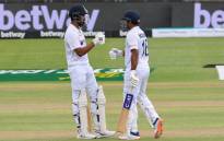India's KL Rahul (L) and India's Mayank Agarwal (R) bump fists between overs during the first day of the third Test cricket match between South Africa and India at Newlands stadium in Cape Town on 11 January 2022. Picture: RODGER BOSCH/AFP