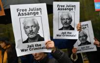 Demonstrators hold placards calling for WikiLeaks founder Julian Assange to be freed and not extradited to the US outside Westminster Magistrates Court in London on 21 October 2019 ahead of a case management hearing in Assange's case. Picture: AFP