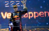 2021 FIA Formula One World Champion Red Bull's Dutch driver Max Verstappen celebrates on the podium of the Yas Marina Circuit after the Abu Dhabi Formula One Grand Prix on 12 December 2021. Picture: ANDREJ ISAKOVIC/AFP
