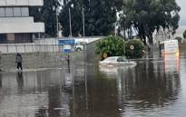 Vehicles negotiate a flooded intersection in Sacks Circle in Bellville, Cape Town after heavy rain on 14 June 2022. Picture: Supplied