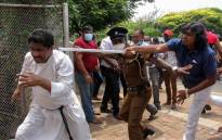 Demonstrators and government supporters clash outside the President's office in Colombo.
