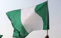 Nigerian lawyers hold up the national flag as they assemble at the secretariat of the Nigerian Bar Association during a protest in Abuja over the suspension of Chief Justice of Nigeria (CJN) in Abuja on 28 January 2019. Picture: Sodiq Adelakun/AFP
