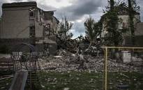 A man walks in front of a destroyed school in the city of Bakhmut, in the eastern Ukranian region of Donbas, on May 28, 2022, on the 94th day of Russia's invasion of Ukraine.
