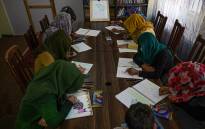 In this picture taken on December 11, 2021, women and girls attend a drawing class in a shelter for Afghan women and girls victims of gender violence in Kabul.  Picture: AFP.