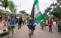 Protesters march at Alausa, the Lagos State Secretariat, in Lagos on 20 October 2020, after the Governor of Lagos State, Sanwo Olu, declared a 24 hour curfew in Nigeria's economic hub Lagos as violence flared in widespread protests that have rocked cities across the country. Picture: AFP