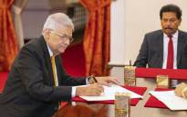 This handout photograph taken on 12 May 2022 and released by Sri Lanka President's Office shows the new prime minister Ranil Wickremesinghe (L) attending his swearing in ceremony at the President's Palace in Colombo. Picture: Sri Lanka President's Office / AFP