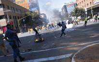 South African Police Service (SAPS) officers use teargas to disperse students during a protest in Braamfontein, Johannesburg, on March 10, 2021. Picture: Emmanuel Croset/AFP
