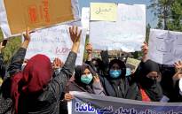    Afghan women hold placards as they take part in a rare protest in Herat on 2 September 2021. Picture: AFP