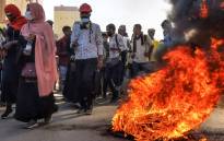 Sudanese protesters rallying against the military, walk past burning tyres in the capital Khartoum, on January 6, 2022. Picture: AFP 