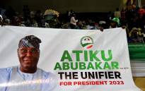 Supporters hold a banner of Nigerian former Vice President Atiku Abubakar during the opposition Peoples Democratic Party's (PDP) primaries in Abuja, on May 28, 2022. Former Nigerian vice president Atiku Abubakar on May 28, 2022 won the opposition party PDP's primary to choose its candidate for the 2023 presidential election, according to ballot results. Picture: PIUS UTOMI EKPEI / AFP