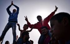 FILE: Kurdish refugees who managed to leave the VIAL detention center on the island of Chios are seen as they protest against deportations to Turkey at the island’s port where they are camping out on 5 April 2016. Picture: Louisa Gouliamaki/AFP.