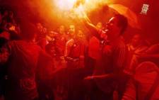 Al Ahly fans celebrate in Cairo after defeating Orlando Pirates 2-0 in the second leg of the CAF champions league final on November 10 2013. Picture: AFP.