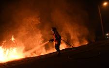 A firefighter tries to extinguish a fire in Cabanoes near Louzan as wildfires continue to rage in Portugal on October 16, 2017. Picture: AFP.