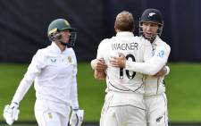 New Zealand's paceman Neil Wagner celebrates his wicket of South Africa's Rassie van der Dussen with a teammate Will Young on 27 February 2022.