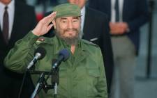 This file photo taken on 12 October 1995 shows Cuban President Fidel Castro saluting journalists. Picture: AFP.