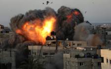A ball of fire erupts from a building in Gaza City's Rimal residential district on 16 May 2021, during massive Israeli bombardment on the Hamas-controlled enclave. Picture: Bashar TALEB/AFP