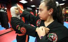 FILE: Kuwaiti Asma Hasnawi (L), a Kajukenbo hybrid martial art assistant-master, practises with her daughter Riham, in a club in Kuwait City on 22 October 2018. Picture: AFP