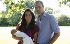 FILE: Prince William, his wife Catherine and their son Prince George, at the Middleton family home in Bucklebury, Berkshire, in early August, 2013. Picture: AFP.
