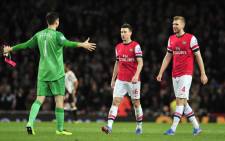 Arsenal's goalkeeper Wojciech Szczesny celebrates at the end of the match with Laurent Koscielny and Per Mertesacker after winning their match against Liverpool at the Emirates Stadium in north London, on 2 November, 2013. Picture:AFP