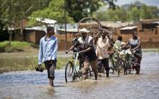 Residents of Phaloni navigate parts of their village by traditional fishing boats after the Sombani River burst its banks. Picture: Aletta Gardner/EWN