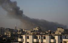 Smoke billows from buildings following an Israeli air strike in Gaza City early on 10 July, 2014. The Israeli air force overnight hit more than 300 Hamas targets in the Gaza Strip in response to rocket fire from the besieged Palestinian territory, an army spokesman said. Picture: AFP.