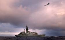 HMAS Perth transits through the Southern Indian Ocean on 13 April as an Orion P-3K of the Royal New Zealand Air Force searches for debris from missing Malaysia Airlines flight MH370. Picture:AFP.