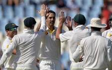 FILE: Australia cricketer Mitchell Johnson celebrates with team-mates after taking the wicket of South Africa's Ryan McLaren, during the fourth day of the first Test match between South Africa and Australia at SuperSport Park in Centurion on 15 February 2014. Picture: AFP