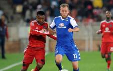 Orlando Pirates defender, Siyabonga Sangweni and Supersport United striker, Jeremy Brockie, fight for the ball during the PSL match on 11 August 2015. The match was called off due to poor lighting. Picture: PSL.
