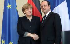 German Chancellor Angela Merkel (L) shakes hands with French President Francois Hollande prior to talks in the chancellery in Berlin on January 27, 2017. Picture: AFP.