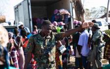 A member of the Mozambican government runs the line at the food truck in a relief camp set up for victims of Cyclone Idai. Picture: Ahmed Kajee/EWN