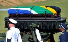 Nelson Mandela's casket is carried by members of the military and police on a gun carriage during his funeral service in Qunu in the Eastern Cape on 15 December 2013. Picture: GCIS.