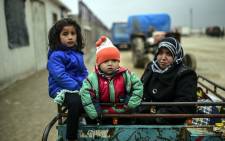 Refugee children arrive at the Turkish border crossing gate as Syrians fleeing the northern embattled city of Aleppo wait on 6 February 2016 in Bab al-Salama, near the city of Azaz, northern Syria. Picture: AFP.