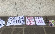 Placards seen at protest art performances outside the Artscape Theatre in Cape Town on 27 March 2021. Picture: Lizell Persens/Eyewitness News