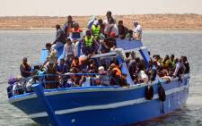 FILE: Migrants arrive at the port in the Tunisian town of Ben Guerdane, some 40 km west of the Libyan border, following their rescue by Tunisias coastguard and navy after their vessel overturned off Libya, on 10 June 2015. Picture: AFP.