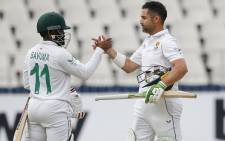 South Africa's Temba Bavuma (L) shakes hands with captain Dean Elgar (2nd L) after South Africa won the second Test cricket match between South Africa and India at The Wanderers Stadium in Johannesburg on 6 January 2022. Picture: PHILL MAGAKOE/AFP