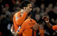 Netherlands' midfielder Virgil van Dijk (L) celebrates with Netherlands' forward Memphis Depay after scoring their fourth goal during the Euro 2020 qualification football match between the Netherlands and Belarus at the Feijenoord stadium in Rotterdam, on 21 March 2019. Picture: AFP
