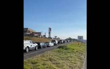 Scores of motorists are queuing at South Coast Ultra City (Umgababa) on 14 July 2021. This is one of the few fuel stations that are operational in eThekwini following looting sprees that have affected various businesses in KZN. Picture: Nkosikhona Duma/Eyewitness News.