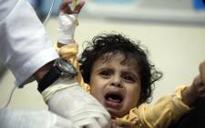 FILE: A Yemeni child, suspected of being infected with cholera, receives treatment at a hospital in Sanaa on 15 May 2017. Picture: AFP