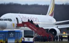 Police evacuate passengers on 17 February, 2014 from the Ethiopian Airlines flight en route to Rome, which was on hijacked and forced to land in Geneva, where the hijacker has been arrested, police said. Picture: AFP.