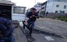 Police officers monitor protesters in Langa on 1 September 2015. Picture: Lauren Isaacs/EWN