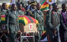The coffin bearing the late Robert Mugabe is led by a procession to the waiting hearse. Picture: Thomas Holder/EWN.