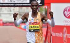Kenya's Eliud Kipchoge poses for a photograph after winning the elite men's race of the 2019 London Marathon in central London on April 28, 2019. Kenya's Eliud Kipchoge won the men's London Marathon on Sunday in an unofficial time of 2 hours two minutes and 37 seconds - the second fastest time for a marathon. Ben STANSALL / AFP