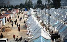FILE: Syrian refugees walk among tents at Karkamis’ refugee camp on 16 January, 2014 near the town of Gaziantep, south of Turkey. Picture: AFP.