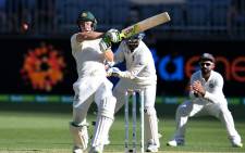 Australia's batsman Tim Paine (L) plays a shot during day one of the second Test cricket match between Australia and India in Perth on 14 December 2018. Picture: AFP