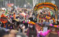 People take part in the Day of the Dead parade in Mexico City on 28 October 2017. Picture: AFP.